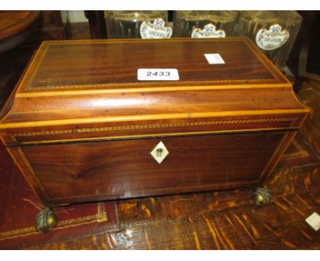 Regency rosewood and inlaid sarcophagus shaped three division tea caddy raised on gilt brass claw and ball feet