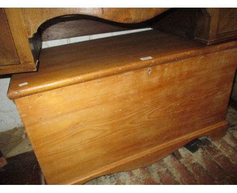 Late 19th Century stripped and polished pine trunk having hinged cover with candle box raised on bracket feet