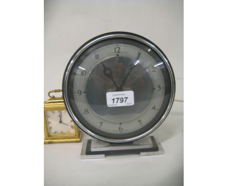 Art Deco black and chrome cased circular electric mantel clock and a small brass cased carriage type clock