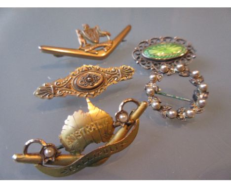 Victorian 9ct gold bar brooch, an oval silver and enamel decorated brooch and two other bar brooches