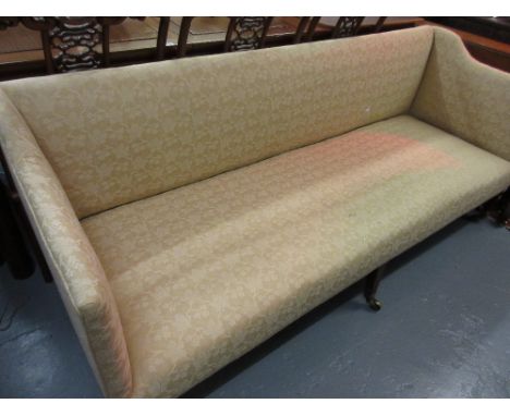 Edwardian three seat sofa in George III style having beige upholstery, raised on square tapering inlaid supports with brass c