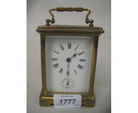 Brass cased carriage clock with enamel dial, Roman numerals and alarm dial with single train movement