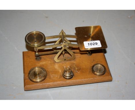 Pair of oak and brass postal scales