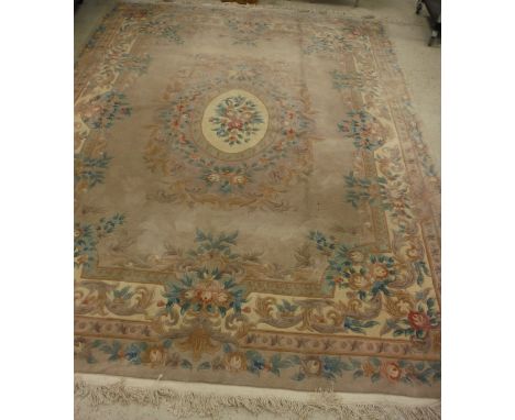 A Chinese superwash carpet, the central panel set with floral decorated medallion on a lilac and cream ground, within a stepp