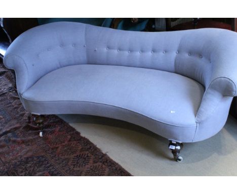 A 19th Century sofa, the shaped back with scroll arms to shaped front raised on ringed and turned legs to brass caps and chin