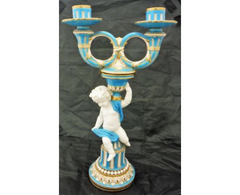 A Minton twin branch candelabra, the body with putto and gilt embellishments CONDITION REPORTS Numerous areas of wear to and 