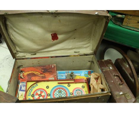 A dome top trunk containing various vintage games, together with six various trunks, suitcases and a mirror