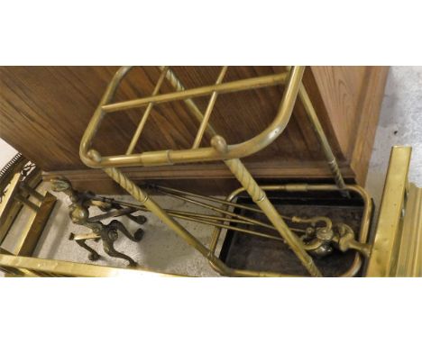 Two brass fire kerbs, a pair of brass fire dogs, brass fireside companion tools and a brass six section umbrella stand