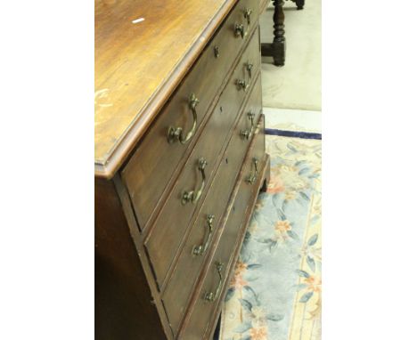 A 19th Century mahogany bachelors chest, the plain top over a fitted drawer with baize slide and side compartment over three 