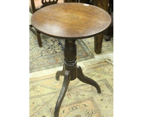 A 19th Century oak occasional table, the circular snap top on a turned pedestal to splayed tripod base