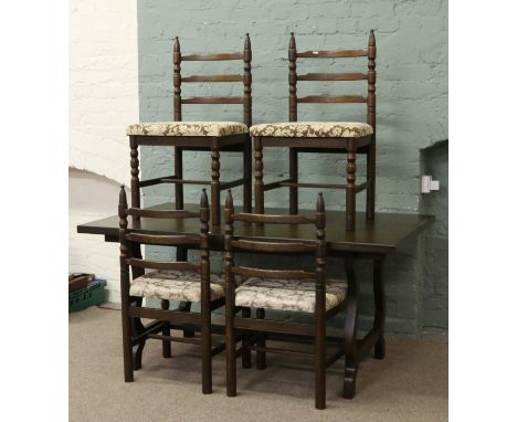 A three part dining room suite; consisting of carved and panelled oak sideboard, extending dining table with inbuilt leaf and
