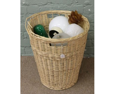 A basket of various glass light shades to include milch, clear, and coloured examples.
