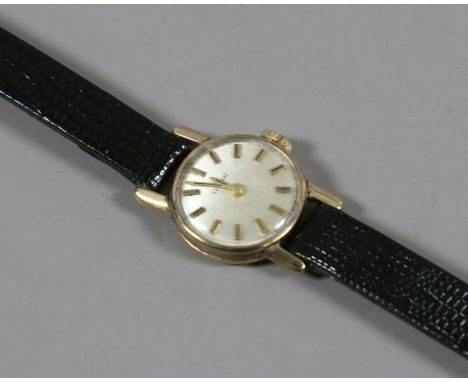 A ladies 9ct gold manual Tissot wristwatch. With satin dial and baton markers,  Condition Report. To be used as a guide only.