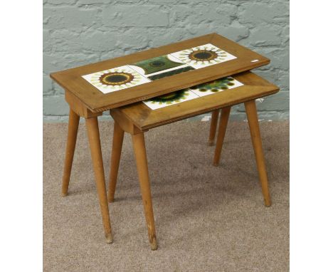 A pair of Ercol style tiled top occasional tables.