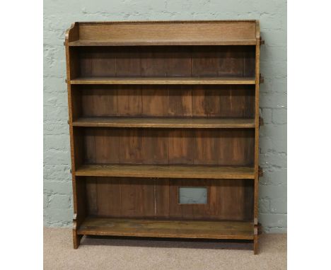 An Arts and Crafts oak five shelf bookcase, peg construction.