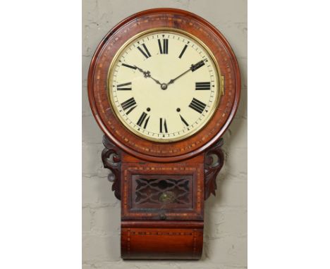 A Victorian walnut cased eight day drop dial wall clock. Inlaid, with carved mouldings and enamel dial. Striking hourly on a 