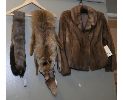 Two ladies fur stoles and a mink coat with original guarantee and receipt.