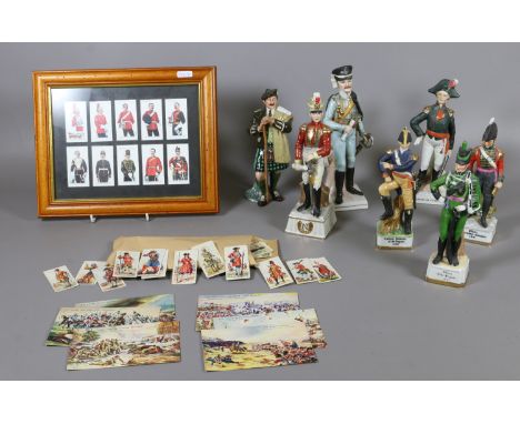 Six ceramic models of soldiers, Royal Doulton model of the laird HN 2361, framed Ogdens cigarette cards 'soldiers of the king