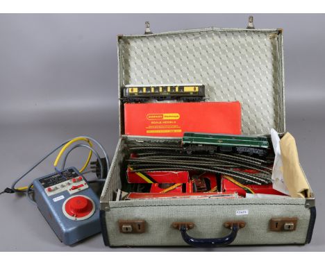 A case and contents of Triang o'-o' gauge model railway items, engine, rolling stock, track and power unit etc.