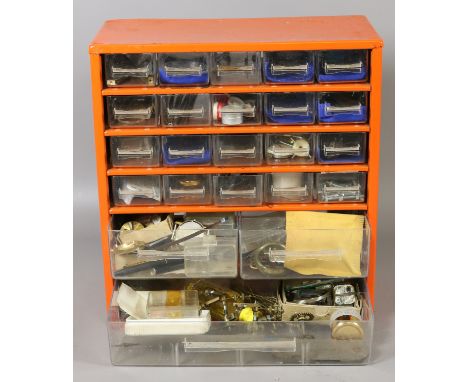 A bank of twenty three drawers and contents of watch makers tools and watch parts including fittings, dials, movements etc.