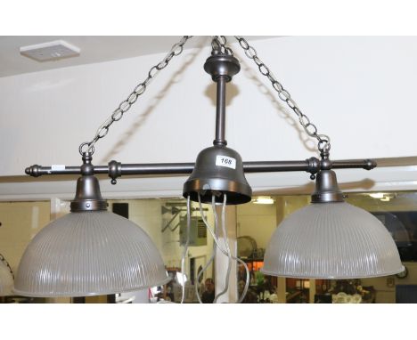 A two branch over table ceiling light fitting with ribbed glass shades
