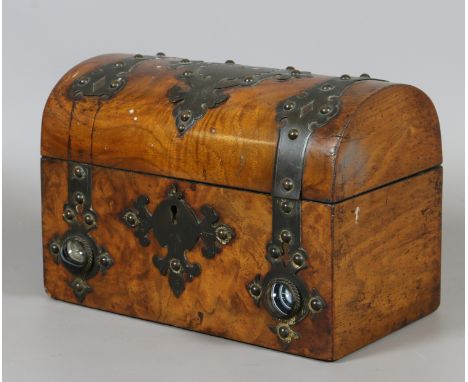 A Victorian figured walnut dome top tea caddy with brass strapwork and agate medallions.