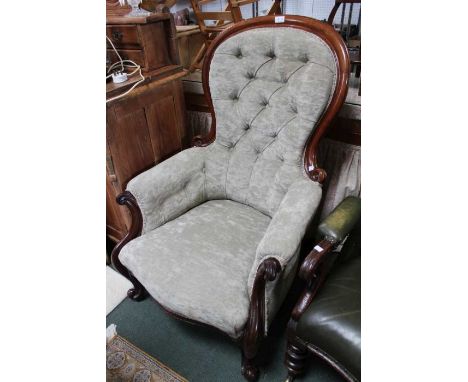 A Victorian show wood framed button back salon armchair, scroll feet with green fabric upholstery.