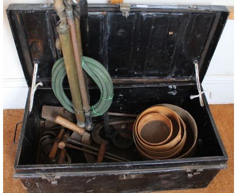 A tin trunk with tools.