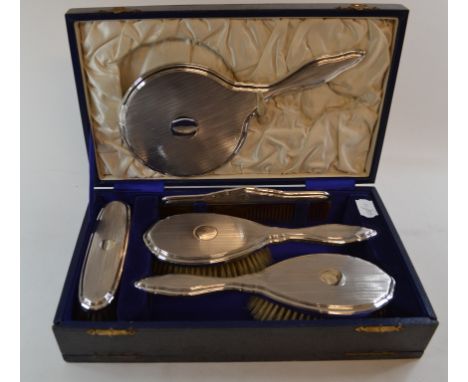 A silver backed five-piece dressing table set, with engine turned decoration,Birmingham 1925, cased, six silver teaspoons, si