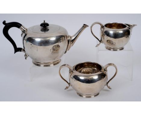 A silver teapot, Thomas Bradbury & Son, London 1928, 13.5 cm high, and a similar sugar bowl and milk jug, Thomas Bradbury & S