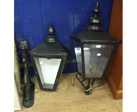 An outdoor black painted metal lantern, with bracket, 38 cm wide, and a similar wall mounted lantern (2)