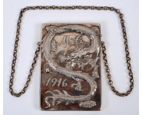 A Chinese silver coloured metal visiting card case, initialled N C and dated 1916, decorated a dragon to one side, the other 