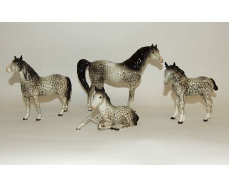 A Beswick Arab Xayal, 1265 (leg and ear damaged), a Pony, head up, 1197 (ears restored), a foal, lying, 915 (ears and leg res