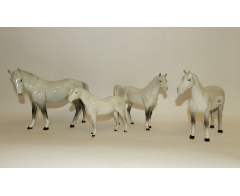 A Beswick Mare, facing left, grey, 976, a Huntsman's Horse, grey, 1484 (underglaze chip to ear), a Pony, head up, grey, 1197 