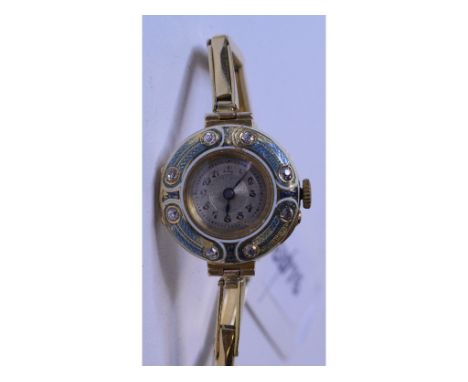 A lady's 18ct gold wristwatch, with an eight stone diamond and enamel bezel   Condition report  approx 24.3 g (all in)Report 