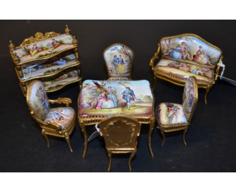 A Viennese enamel and gilt metal doll's house suite, comprising a three tier etagere, 8.5 cm high, a table, 5.5 cm high, two 