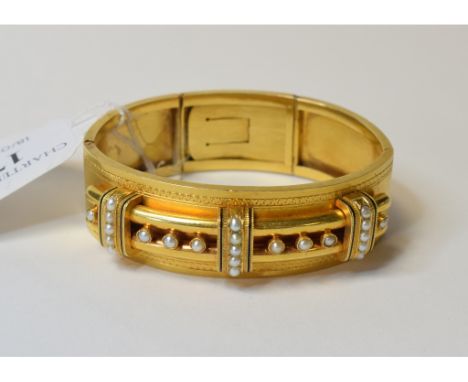 A late Victorian gilt metal, enamel and seed pearl bangle   Condition report  Report by GHApprox. 36 g.  Diameter when clippe