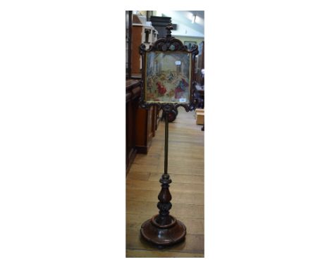 A Victorian rosewood pole screen, with needlework panel