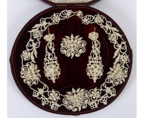 A 19th century suite of seed pearl jewellery, comprising a necklace, a pair of drop earrings, and a brooch, cased  See illust