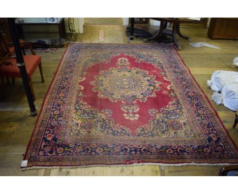 A Persian carpet, decorated a central lozenge on a purple ground, within a multi border, 537 x 243 cm