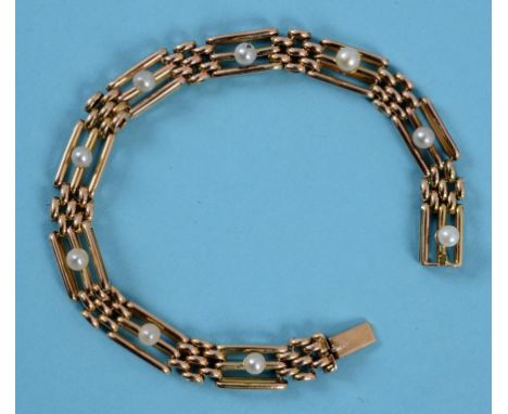 A pendant, set an opal within two rows of diamonds  See back cover colour illustration