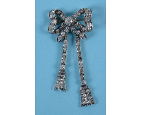 A diamond bow brooch, having two tassels, of differing lengths  See back cover colour illustration