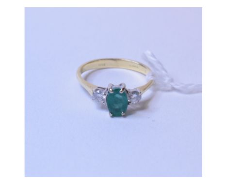 An 18ct gold, emerald and diamond three stone ring, approx. ring size K