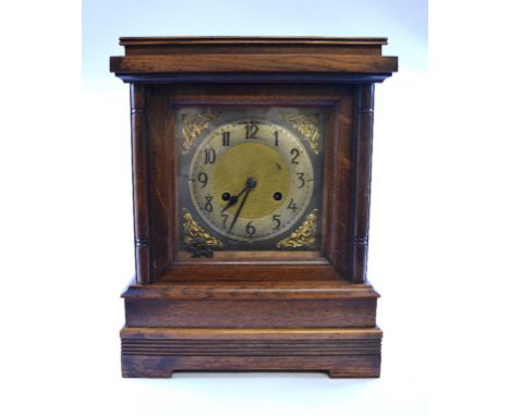 An early 20th century mantel clock, in an oak case, 28 cm wide