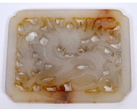 A Chinese carved and pierced white jade plaque, decorated a dragon, 6 cm wide  See illustration