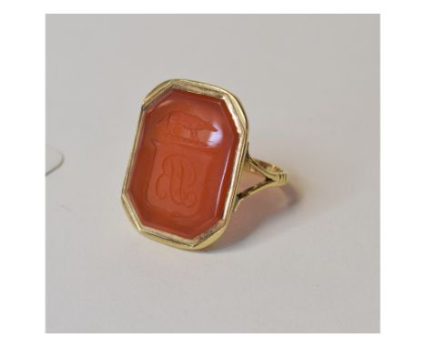 A yellow coloured metal and intaglio carnelian signet ring, approx. ring size M½, apparently unmarked