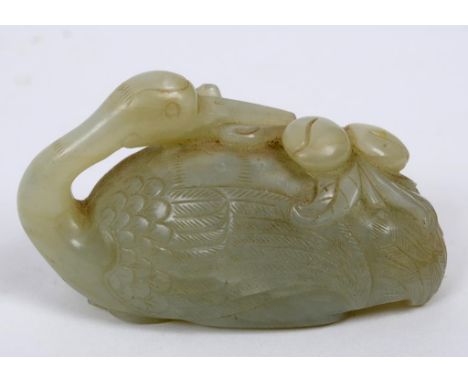 A Chinese jade crane and peaches carving, the bird's head resting on a peach branch (tip of beak and part of leaf lacking), 6
