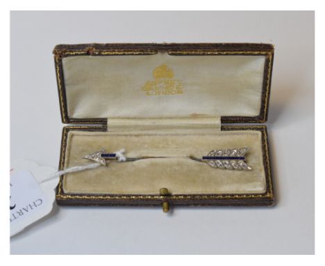 A yellow and white coloured metal arrow brooch, set diamonds and sapphires, in an Asprey box   Condition report  Modern