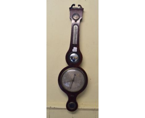 A barometer, with thermometer/damp dial and mirrors, in a mahogany case, 97.5 cm high, and a wall clock (2)