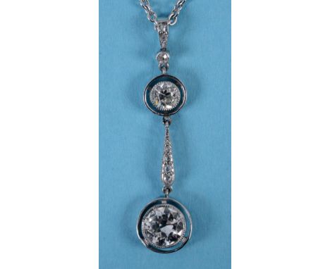 A diamond drop pendant, on a 9ct white gold chain  See back cover colour illustration